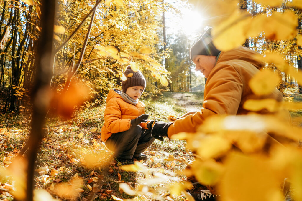 father and son having fun in autumn forest 2023 11 27 05 01 04 utc